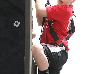St. Rose School fifth-grader Jayden Maggs goes out of his element as he climbs a rock wall during Camp Character on Tuesday. The event at the Girard school featured team-building and confidence boosting
exercises.