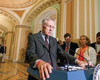 Senate Majority Leader Harry Reid, D-Nev., speaks to reporters Tuesday at the Capitol in Washington, D.C., after a Democratic caucus lunch. A bill to renew more than 50 expired tax breaks for businesses and individuals cleared a key hurdle in the Senate on Tuesday.