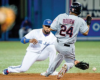 The Indians’ Michael Bourn is safe at second base after Blue Jays shortstop Jose Reyes misses the catch on a
throwing error by first baseman Adam Lind during the third inning of their baseball game Wednesday in Toronto. The Indians routed the Blue Jays, 15-4.