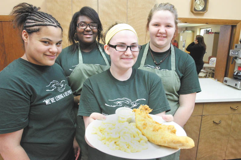 Among the members of Girls of Joy who served a fish dinner at West Side Community Center recently are, from left, Sherri Ann Odem, Kayla Taylor, Victoria Rousher and Alexis Park. As members of the nondenominational group, the girls experience opportunities to perform community work while developing job skills.
William D. Lewis | The Vindicator   