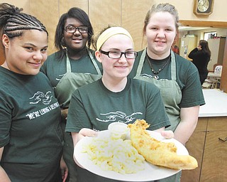 Among the members of Girls of Joy who served a fish dinner at West Side Community Center recently are, from left, Sherri Ann Odem, Kayla Taylor, Victoria Rousher and Alexis Park. As members of the nondenominational group, the girls experience opportunities to perform community work while developing job skills.
William D. Lewis | The Vindicator   