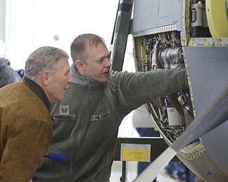 Katie Rickman | The Vindicator.Tech Sergeant Shawn Froehling (ON RIGHT) shows the T56 Engine (is the engine of a C130) to Chuck Hemmi of Jerfferson at Thunder Over the Valley May 17, 2014.