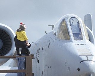 Katie Rickman | The Vindicator.Mark Greb holds his son Markus, 3, up at a F-16 jet at Thunder Over the Valley May 17, 2014.
