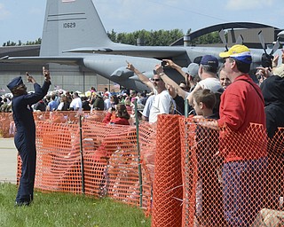 Katie Rickman | The Vindicator.Darrick Lee (Public Affairs Officer for The Thunderbirds) counts down as each F-16 prepares to take off during Thunder Over the Valley May 18, 2014.