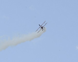 Katie Rickman | The Vindicator.Third Strike Wingwalking flies during Thunder Over the Valley May 18, 2014.  Pilot Marcus Ping flies as wing walker Carol Pilon stands on top of the plane as it flies.