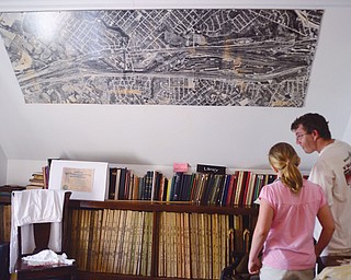 Marty William of Struthers and his daughter, 9-year-old Mary William, look through old Struthers High School yearbooks during the Struthers Historical Society’s open house Sunday.