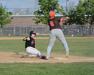 Girard baserunner Austin DeGregory slides into third base as East Palestine’s Blaze Camberlain awaits a throw during Sunday’s tournament game at Cene Park in Struthers. Girard won, 8-3, and advances to the Division III district semifinals to face South Range on Wednesday.