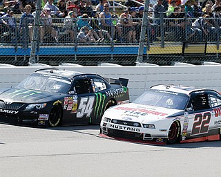 Ryan Blaney, right, tries to pass Sam Hornish Jr. during the NASCAR Nationwide auto race Sunday at Iowa Speedway in Newton, Iowa. Hornish won the race, and Blaney finished in second place.