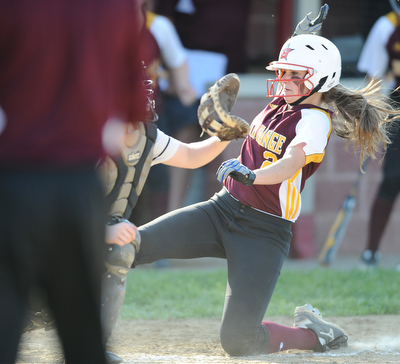 NORTH LIMA, OHIO - MAY 19, 2014: Base runner Jessica Skirpak #2 of South Range slides into home plate to score the game winning run in the bottom of the 9th inning during a game at South Range High School. (Photo by David Dermer/ Youngstown Vindicator)