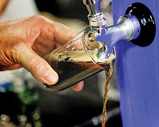 Bob Baker of Warren pours Ayinger, a German beer, during the 4th Annual Big Tap In at the Shepherd Event Center in Boardman.