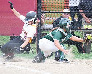 South Range baserunner Stevie Taylor (8) eludes Ursuline catcher Dana Creatore to score during their Division III district championship game Tuesday in Beaver Township. The Raiders won, 5-4.