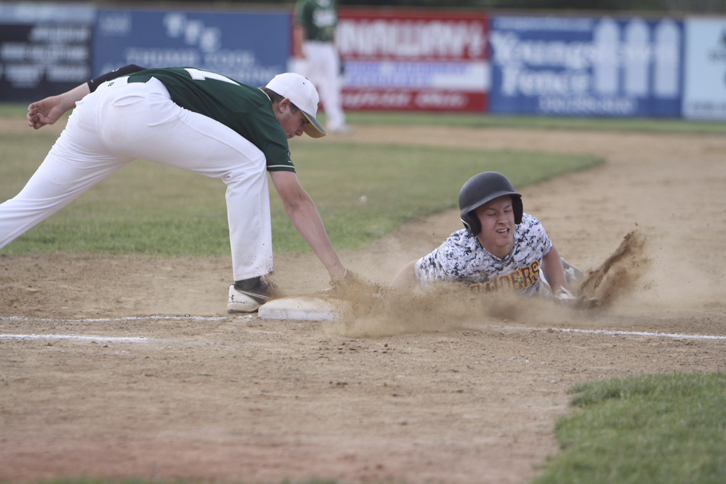 South Range baserunner, Dylan Keller (11), slides in safely to first beating out the pick off by Ursuline's Dion Felger (31) during Thursday evenings matchup at Bob Cene Park in Struthers.  Dustin Livesay  |  The Vindicator  5/22/14  Struthers.