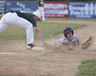South Range baserunner, Dylan Keller (11), slides in safely to first beating out the pick off by Ursuline's Dion Felger (31) during Thursday evenings matchup at Bob Cene Park in Struthers.  Dustin Livesay  |  The Vindicator  5/22/14  Struthers.