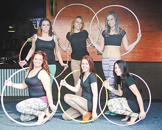 Katie Rickman | The Vindicator: The six members of Infini-Tribe, who entertain with a program of hula-hoop tricks and routines, are, from left in front, Katie Morris of Austintown, Delia Dow of Boardman and Brittney Marinelli of Boardman; and in back, Erika Smegal of Farrell, Pa., Haley Luckage of Ravenna and Callie Reda of Youngstown. 