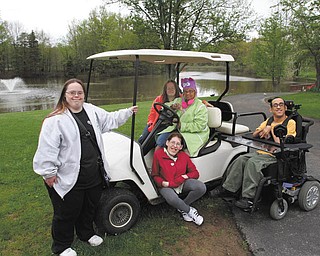 ROBERT K. YOSAY | THE VINDICATOR
Helping to promote the 11th Annual Golden String Drive for the Disabled are, left to right, standing, Samantha McCue; seated in the seat, Diane Dickey and Gaye Weatherall; seated on floor of the cart, Nikki Taub, and in the wheelchair is Alex Rivera.