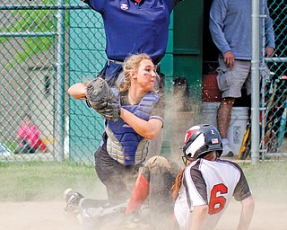 Home plate umpire Rick Anon signals that Canfield’s Rebecca Armstrong is safe as she slides into the plate to
score the winning run ahead of the tag by Lakeview catcher Samantha Marino during their Division II district softball semifinal Thursday at Alliance High School. The Cardinals scored three runs in the seventh inning
to rally past the Bulldogs and win 6-5. Canfield advances to the final today against the Poland Bulldogs, who
downed the West Branch Warriors, 6-4, in Thursday’s other Division II semifinal, also at the high school.