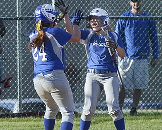 Katie Rickman | The Vindicator.Poland's Chloe Bush (left) celebrates with Amanda Kabetso after she ran in the winning run for Poland during the Division II District Final against Canfield May 23, 2014.