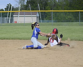Katie Rickman | The Vindicator.Poland's Brielle Nocera tags out Canfield's Caroline Griswold during the 1st inning at Alliance High School May 23, 2014. Poland won the game 6-5.