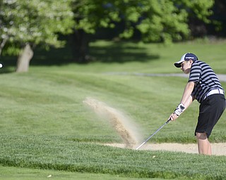 Katie Rickman | The Vindicator.Alec Hamilton, 15, of Austintown hits his ball out of the sand and onto the green during the Greatest Golfer Junior Qualifier May 24, 2014.