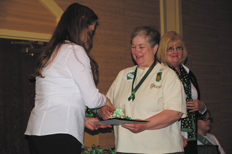 SPECIAL TO THE VINDICATOR
Kathi Kovacic, center, receives the Honor Pin for her volunteer work for Girl Scouts of North East Ohio. She has had a positive impact on the girls for more than 20 years. Kovacic has a knack for helping Girl Scouts to see and develop their potential.