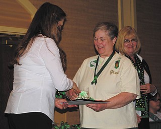 SPECIAL TO THE VINDICATOR
Kathi Kovacic, center, receives the Honor Pin for her volunteer work for Girl Scouts of North East Ohio. She has had a positive impact on the girls for more than 20 years. Kovacic has a knack for helping Girl Scouts to see and develop their potential.