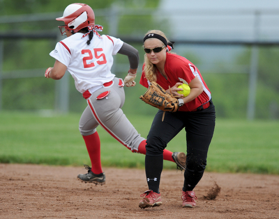 MASSILLON, OHIO - MAY 28, 2014: Infielder Courtney Roth #15 of Manchester prepares to throw the ball to first base for the first out of the bottom of the 3rd inning during a OHSAA tournament game at Massillon Washington High School. Manchester won 4-1. (Photo by David Dermer/Youngstown Vindicator) LaBrae base runner Haley Davies #25 pictured.