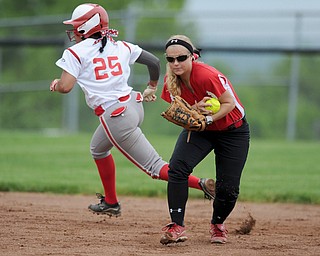 MASSILLON, OHIO - MAY 28, 2014: Infielder Courtney Roth #15 of Manchester prepares to throw the ball to first base for the first out of the bottom of the 3rd inning during a OHSAA tournament game at Massillon Washington High School. Manchester won 4-1. (Photo by David Dermer/Youngstown Vindicator) LaBrae base runner Haley Davies #25 pictured.