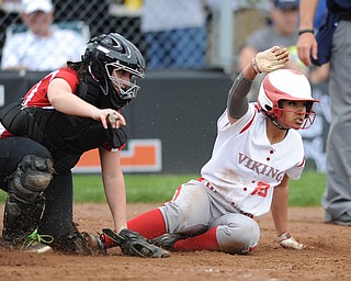MASSILLON, OHIO - MAY 28, 2014: Base runner Haley Davies #25 of LaBrae slides into home plate to score the first LaBrae run in the top of the 3rd inning. Catcher Mackenzie Barker #4 misplayed the ball during a OHSAA tournament game at Massillon Washington High School. Manchester won 4-1. (Photo by David Dermer/Youngstown Vindicator)