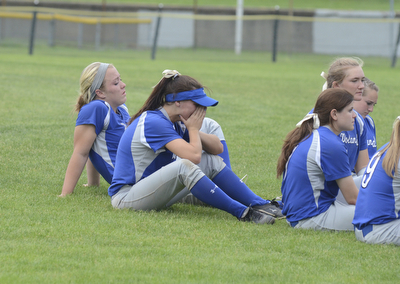 Katie Rickman | The Vindicator.Phoebe Bush cries as the team gathers on the field after losing to Tallmadge 1-5...Taylor Miokovic leans back and listens as the coach talks to the team.