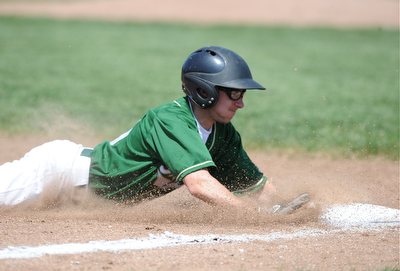 MASSILLON, OHIO - MAY 29, 2014: Base runner Zach Patton #20 of Ursuline slides head first into third base after a pass ball during a OHSAA tournament game at Massillon Washington High School. Ursuline won 7-5. (Photo by David Dermer/Youngstown Vindicator)
