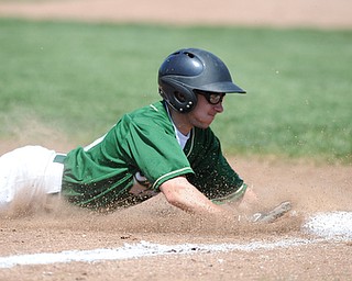 MASSILLON, OHIO - MAY 29, 2014: Base runner Zach Patton #20 of Ursuline slides head first into third base after a pass ball during a OHSAA tournament game at Massillon Washington High School. Ursuline won 7-5. (Photo by David Dermer/Youngstown Vindicator)