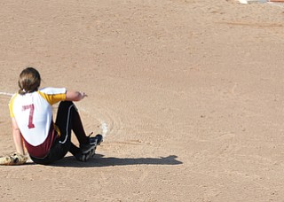 MASSILLON, OHIO - MAY 29, 2014: Pitcher Caragyn Yanek #7 sits on the ground after being struck in the ankle with a line drive hit in the 4th inning during a OHSAA tournament game at Massillon Washington High School. Independence won 3-0. (Photo by David Dermer/Youngstown Vindicator)
