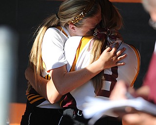 MASSILLON, OHIO - MAY 29, 2014: Codi Taylor #4 hugs teammate Stevie Taylor #4 in the dugout after a OHSAA tournament game at Massillon Washington High School. Independence won 3-0. (Photo by David Dermer/Youngstown Vindicator)