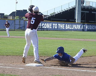 Katie Rickman | The Vindicator.Polands Marty Malenic (11) slides back into first base safe after trying to steal third during the first inning, Woodridge's Tom Finegan (5) stands on first base and tries to tag him out.