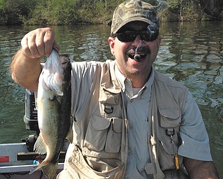 James Lewandowski with his second fish and a fine cigar.