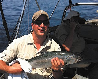 Here's Dr. DJ Peters of Kalamazoo, Mich., with a salmon he caught in Lake Michigan last summer. He is the son of Dom and Georgie Peters of Poland.