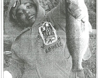 Isiah Givens, 7, of Youngstown, caught this large mouth bass during a fishing open house at Meander Reservoir. The photo was sent by Jerome Givens.