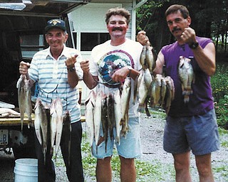 Loren Burns, his son-in-law Mike Fox and his son Bill Burns show off their catches of the day.