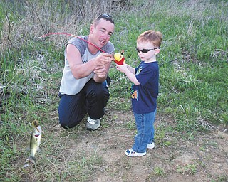 Brad Shultz and his son Peyton on Peyton's first fishing trip on May 3, 2013. They caught this bass. Both reside in New Middletown, Sent by wife and mother, Shannon.