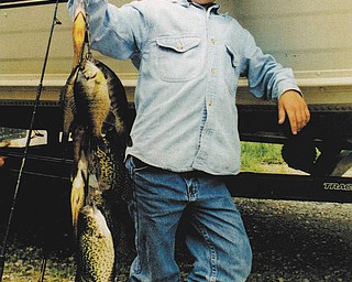 Justin Hoffman, 6, holding the line of fish he and his friend, Jesse Wince caught on a fishing trip with Jesse's father, Mark. The photo was taken by Jesse's mom, Kitty around 1995. All are from North Lima.