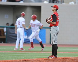 BLOOMINGTON, INDIANA - MAY 30, 2014: Pitcher Anthony Konders #33 of Youngstown State reacts to watching base runner Kyle Schwarber #10 of Indiana trot around the bases after hitting a 3 run home run during Friday nights regional tournament game against Indiana University. (Photo by David Dermer/Youngstown Vindicator)
