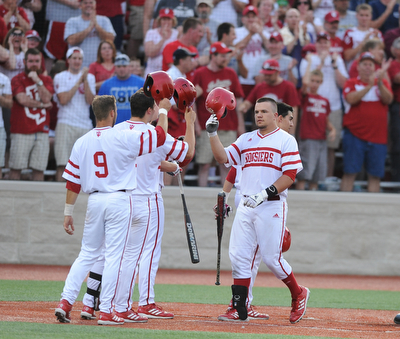 BLOOMINGTON, INDIANA - MAY 30, 2014: Base runner Kyle Schwarber #10 of Indiana is congratulated by teammates #9 Casey Rodrigue, #6 Sam Travis, and #1 Nick Ramos after he hit a 3 run home run during Friday nights regional tournament game against Youngstown State. (Photo by David Dermer/Youngstown Vindicator)
