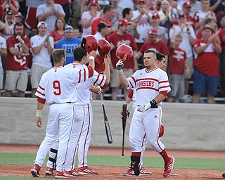 BLOOMINGTON, INDIANA - MAY 30, 2014: Base runner Kyle Schwarber #10 of Indiana is congratulated by teammates #9 Casey Rodrigue, #6 Sam Travis, and #1 Nick Ramos after he hit a 3 run home run during Friday nights regional tournament game against Youngstown State. (Photo by David Dermer/Youngstown Vindicator)