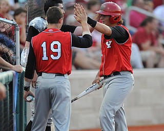 BLOOMINGTON, INDIANA - MAY 30, 2014: Base runner Brent Gillespie #11 of Youngstown State is congratulated by teammates Jared Wight #27 and Alex LArivee #19 after scoring the second YSU run of the game during Friday nights regional tournament game against Indiana University. (Photo by David Dermer/Youngstown Vindicator)