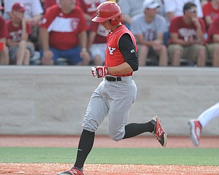 BLOOMINGTON, INDIANA - MAY 30, 2014: Base runner David Saluga #3 of youngstown State steps on home plate to score the first YSU run of the game during Friday nights regional tournament game against Indiana University. (Photo by David Dermer/Youngstown Vindicator)