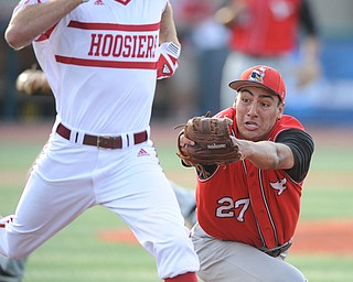 BLOOMINGTON, INDIANA - MAY 30, 2014: Pitcher Jared Wight #27 of Youngstown State dives to attempt to tag out a sprints base runner Tim O'Conner #36 of Indiana, O'Conner would be safe on the play during Friday nights regional tournament game against Indiana University. (Photo by David Dermer/Youngstown Vindicator)