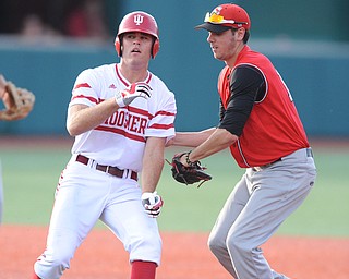 BLOOMINGTON, INDIANA - MAY 30, 2014: Infielder Phil Lipari #13 of Youngstown State tags out base runner Tim O'Conner #36 of Indiana after he was caught in a run down during Friday nights regional tournament game against Indiana University. (Photo by David Dermer/Youngstown Vindicator)