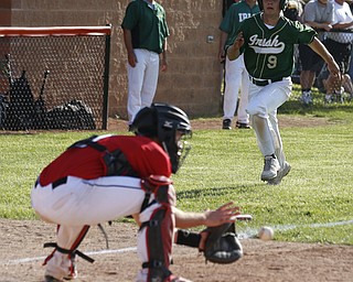 Ursuline's #9 Joel Hake is gunned down at home. Orrville's #9 Layne Scheufler applies the tag.