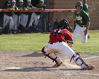 Ursuline's #9 Joel Hake is gunned down at home. Orrville's #9 Layne Scheufler applies the tag.