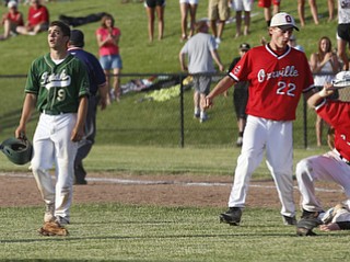 Ursuline's#9 Joel Hake laments their loss as Orrville celebrates victory.